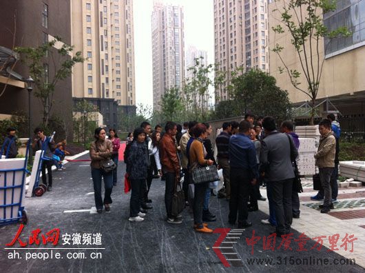 業主們圍在小區門口討說法。 業主們圍在小區門口討說法。