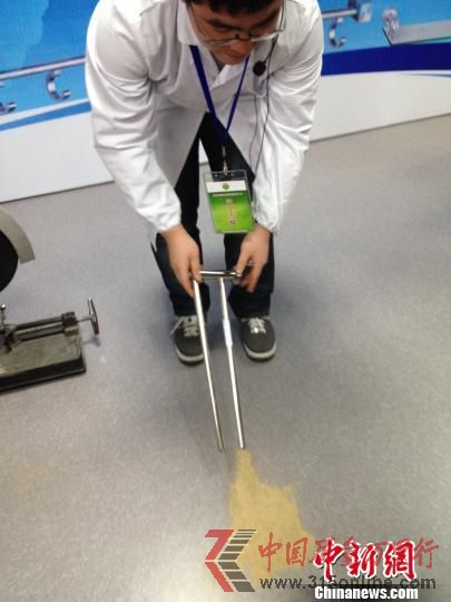 浙江消保委工作人員切割開被灌充進沙石的不合格“毛巾架” 肖娜 攝